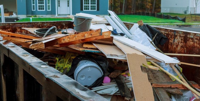 different items in a roll off dumpster