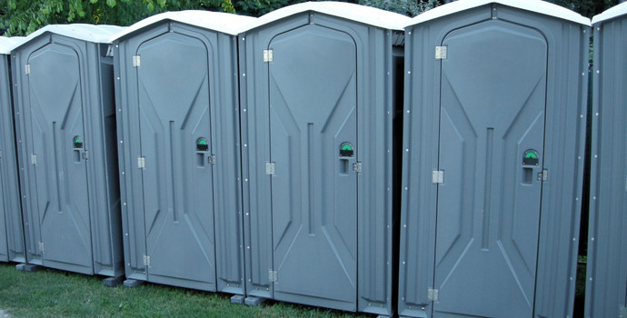 several gray portable toilets