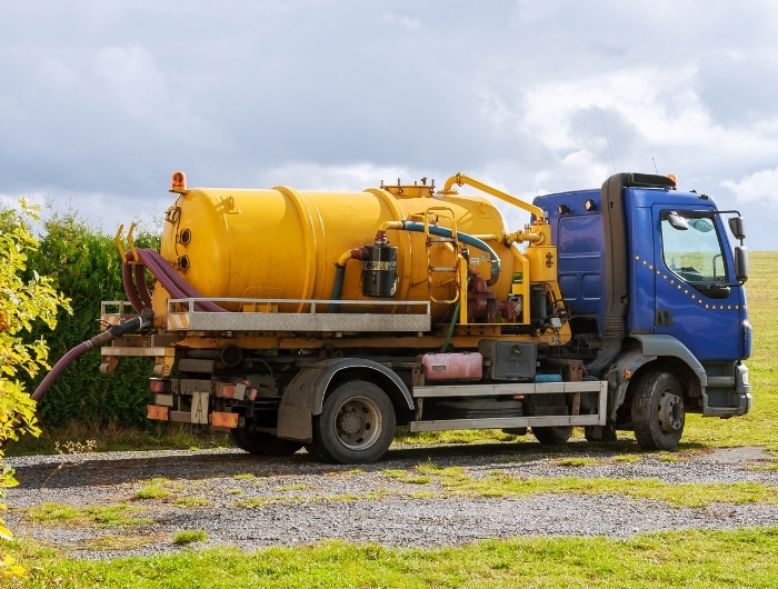 truck sucking water in a pond