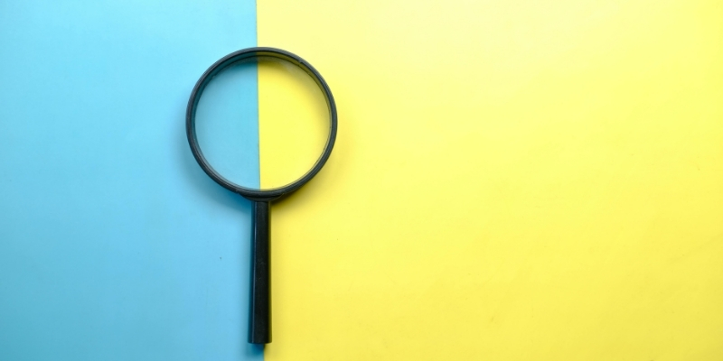 magnifying glass on blue and yellow background